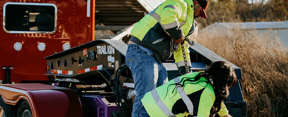 Man and woman working on truck wearing apparel from MyTrucker Pro